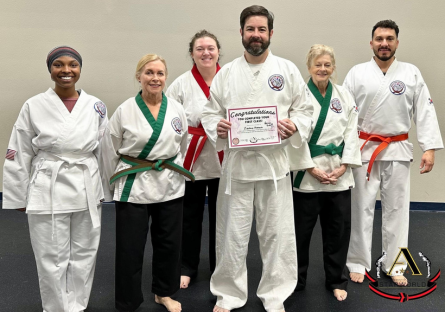 Zachary Kovach posing with 5 other martial arts students. He is holding a certificate that says Congratulations You completed your first class!