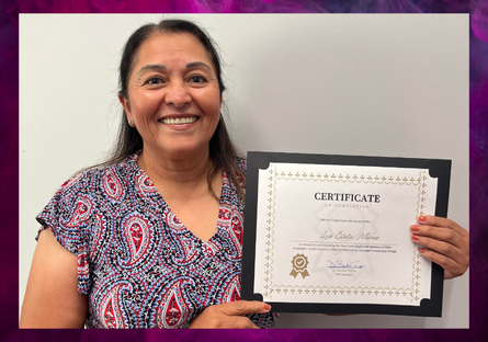 Student, Estela Munoz, holding her ESOL course completion certificate.