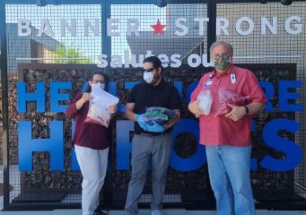 Banner employees receiving ear guards from EMCC